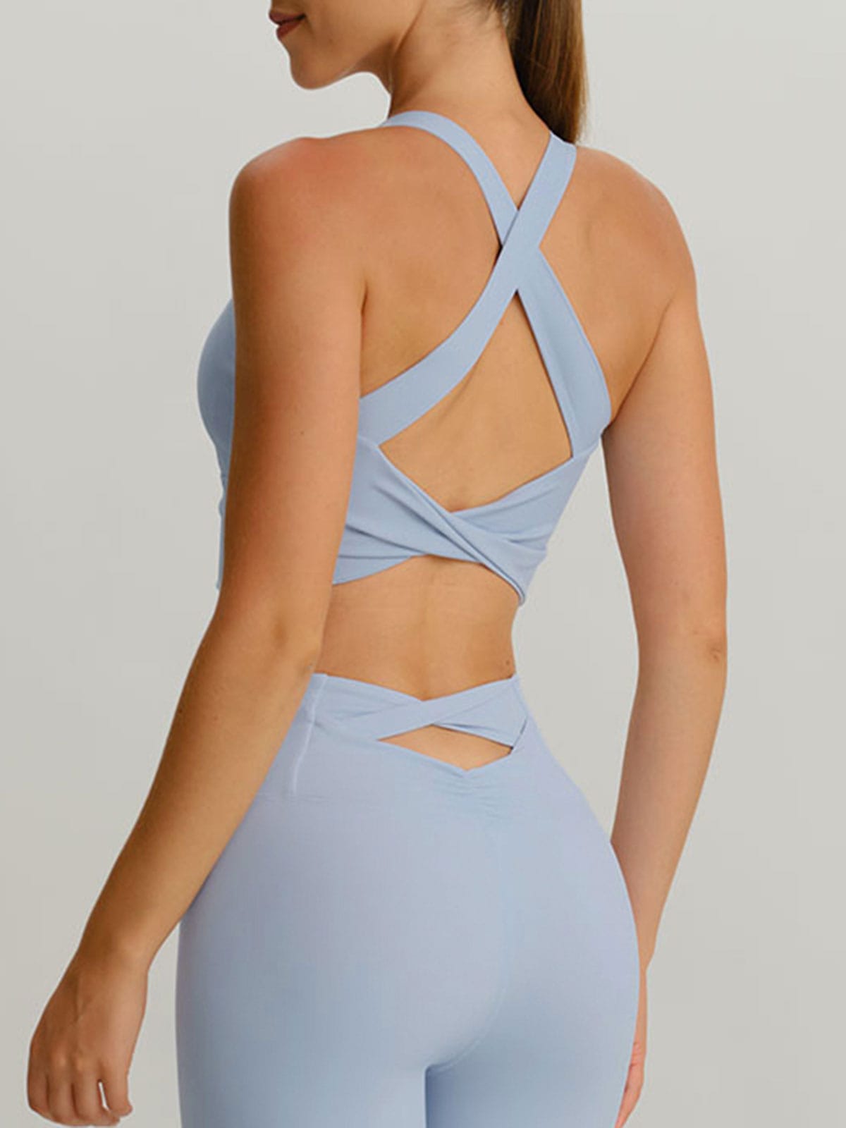 women_s-knitted-nylon-yoga-sports-bras-sustainable-yoga_tops-5bfiyp Light Blue Twist X-Cross Sports Bra - Light Support - Image 1